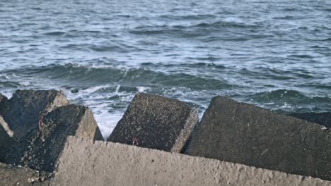 Concrete-breakwaters.-Water-splash-on-pier-rock.-Sea-waves-crashing-on-rock